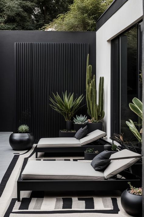 Embrace minimalism with this sleek outdoor lounge, featuring clean lines and a sophisticated black and white palette. Comfort meets style in the sun loungers, accented with textured cushions, set against a backdrop of striking desert plants. This space is a testament to modern design in harmony with nature. #MinimalistDesign #OutdoorLounge #DesertChic #ModernGarden #TexturedDecor #StylishOutdoors Barbacoa Jardin, Textured Cushions, Black And White Palette, In Harmony With Nature, White Palette, Sun Loungers, Harmony With Nature, Patio Garden Design, Small Balcony Decor