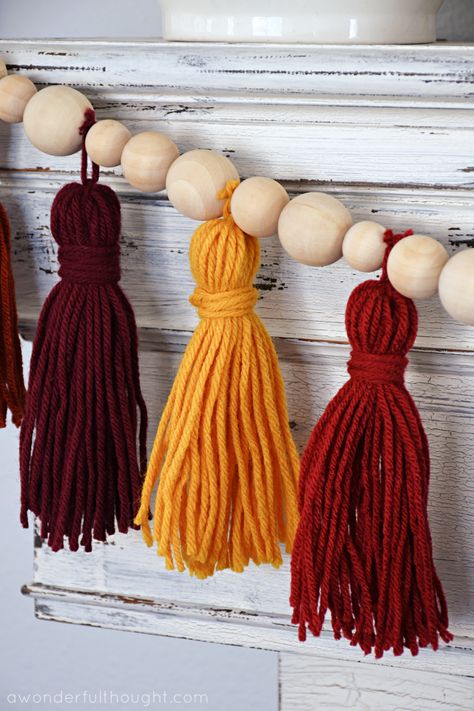 DIY tassel garland - A Wonderful Thought Yarn Tassels Diy, Diy Garland With Ribbon, Homemade Tassel Garland, How To Make Tassel Garland, Halloween Diy Garland, Tassel Garland Diy, Diy Tassel Ornaments, Diy Beaded Tassel Garland, Yarn Tassel Diy