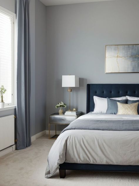 Create a calming atmosphere in your bedroom with blue-gray walls adorned with framed abstract art. Add a touch of elegance by incorporating metallic accents such as silver or gold picture frames. Steel Blue Bedroom Ideas, Navy And Silver Bedroom, Beige And Navy Bedroom, Navy Grey Bedroom, Navy And Beige Bedroom, Blue Grey Bedroom Ideas, Navy Blue And Grey Bedroom, Blue And Grey Bedroom Ideas, Navy Bedroom Ideas