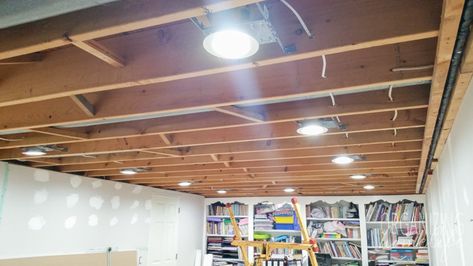 Lights For Basement Ceilings, Lights For Unfinished Basement Ceiling, Installing Can Lights Ceilings, How To Install Can Lights Diy, Basement Rafter Lighting, Basement Open Ceiling Lighting Ideas, Led Can Lights Ceilings, Basement Pot Lights, Basement Lighting Ideas Exposed Ceilings