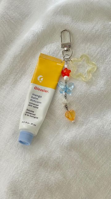 tiffany ♡ on Instagram: "I’ve been seeing these lip balm keychains pop up on social media and love any excuse to use my beads :D  - - #beads #beadedkeychain #lipbalm #glossier #glossierlipbalm #balmdotcom #lipbalmkeychain #keychains" Lip Balm Holder Keychain, Lip Balm Keychain Diy, Lip Gloss Keychain Diy, Glossier Keychain, Lipbalm Keychains, Lip Decor, Lipgloss Keychain, Lip Gloss Keychain, Lip Balm Keychain