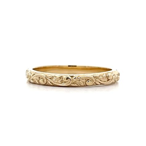 Designed in house by our expert jewelers – this custom modern wedding band is vintage inspired and beautiful. This new By Filigree engraved wedding band features a floral engraved pattern in 14 karat yellow gold. The swirling floral motif decorates the outer shank of the 2.79mm wide band. An unconventional wedding band that is truly unforgettable. Pair this wedding ring with a Yellow Gold Engagement Ring or wear in a right hand stack! Baroque inspired and modern made. Embossed Engagement Ring, Vintage Floral Wedding Band, Gold Filigree Engagement Ring, Ornate Wedding Band, Antique Wedding Bands For Women, Intricate Wedding Band, Art Deco Gold Ring, Engraved Engagement Ring Band, Engraved Wedding Bands For Women