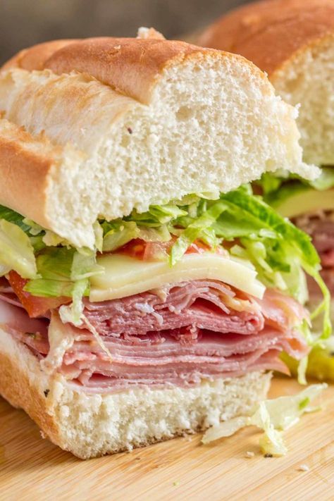 A delicious and EASY homemade Italian sub sandwich recipe loaded with meats, cheese, veggies and Italian dressing. Italian Hoagie Sandwiches, Grinder Sandwich Recipe, Italian Sub Sandwich, Italian Sandwich Recipes, Italian Subs, Hoagie Sandwiches, Cold Sandwich Recipes, Italian Hoagie, Grinder Sandwich