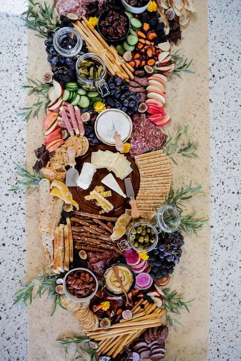 In the last couple of weeks I've learned a new term, grazing table. Have you heard of them before? The best way to describe one is that it's like a giant charcuterie board, typically placed on a table. For my son's 16th birthday he told me that he wanted charcuterie for the food, so in my search for inspirational giant charcuterie spreads, I came across grazing tables. There are many beautiful photos to choose from and people who specialize in creating these too-pretty-to-eat masterpieces.  Toda Forest Theme Charcuterie Board, Charcuterie Board Ideas For Engagement Party, Greenery For Charcuterie Board, Whole Table Charcuterie Board, Charcuterie Island Spread, Butcher Paper Charcuterie Board, Goblincore Birthday, Giant Charcuterie Board, Engagement Lunch