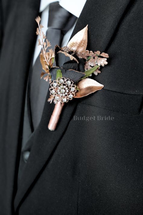 Mens lapel boutonniere with 1 black rose with rose gold glitter tips accents with rose gold leaves and a rose gold jewel. The stems of this boutonniere are wrapped in rose gold ribbon The perfect boutonniere for a navy blue and silver theme wedding!! Color changes are free - if you like this boutonniere but in a differ Black And Rose Gold Suits For Men, Black Silver Gold Wedding, Black And Gold Wedding Groomsmen, Navy Blue And Rose Gold Tuxedo, Black And Rose Gold Tuxedo, Gold Rose Wedding, Black And Rose Gold Groomsmen Attire, Wedding Black And Rose Gold, Rose Gold Groomsmen Attire