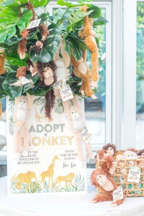 Feast your eyes on this fun safari wild one! Love the 'Adopt a Monkey' party favor table! See more party ideas and share yours at CatchMyParty.com  #catchmyparty #partyideas #safariparty #safari #wildanimals #wildone #boy1stbirthdayparty Safari Animal Party Favors, Wild One Favor Ideas, Adopt Me Safari Party, Wild One Party Bag Ideas, Wild One Adopt An Animal, Monkey Bday Party, Safari Theme Favors, Adopt Me Party Favor, Adopt A Monkey Party Favor