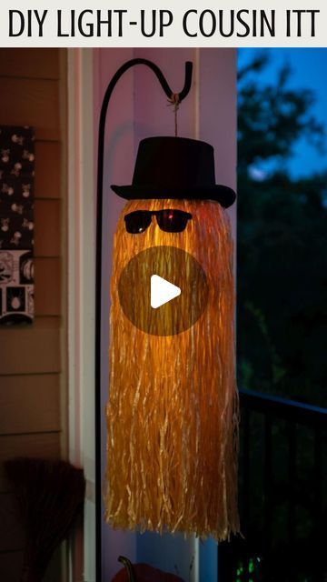 DIY Cousin Itt Pathway Light | DIY Addams Family Cousin It | Step-by-step tutorial for how to make a Cousin It | DIY Halloween decor with Dollar store supplies | Upcycled and Repurposed Halloween decor | Plastic pumpkin candy pail upcycle | Halloween Yard decoration ideas | Hula skirt upcycle | DIY Dollar Tree Halloween craft ideas | #TheNavagePatch | TheNavagePatch.com Dollar Tree Hula Skirt Crafts, Cousin It Decoration, Halloween Pumpkin Bucket Ideas, Farmhouse Halloween Decor Diy, Cheap Diy Halloween Decorations Outdoor, Cousin It Diy, Upcycle Halloween, Diy Dollar Tree Fall Decor, Halloween Yard Decorations Diy