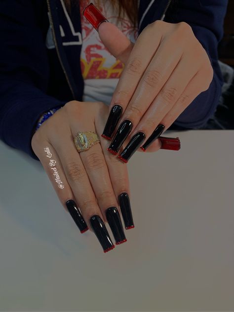 Black Nails W Red Under, Black And Silver Red Bottom Nails, Black Nail Red Under, Acrylic Red Bottom Nails, Long Acrylic Nails Square Red, Glitter Red Bottom Nails, Black Nail With Red Under, Black Red Bottom Nails With Rhinestones, Loubiton Nails