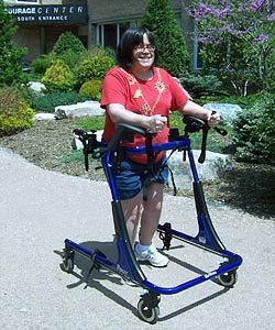 A smiling woman in a Rifton gait trainer (a device designed to offer more support than a typical quad walker) practices forward movement on four wheels. Gait Trainer, Mobility Walkers, Gait Training, Walking Support, Adaptive Devices, Walker For Seniors, Ramp Design, Walking Aids, The Therapist