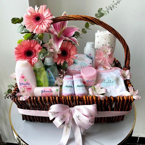 An adorable and a cute gift hamper featuring Johnson's Baby products along with beautiful pink gerberas in a basket. This becomes a perfect gift for newborn baby, brought to you by UAE Flowers Newborn Baby Basket, Newborn Baby Gift Basket, Baby Shower Hamper, Newborn Gift Basket, Baby Bouquet, Hamper Gift Basket, Newborn Baby Girl Gifts, Girl Gift Baskets, Baby Shower Baskets