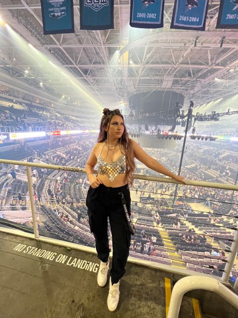 28 year old women with long hair standing inside of a concert venue wearing a silver sequin crop top with black cargo pants and white sneakers Silver Concert Outfit, Concert Outfit Cargo Pants, Eras Outfits, Concert Makeup, Silver Outfits, Space Buns, Concert Outfits, Silver Tops, Cargo Joggers