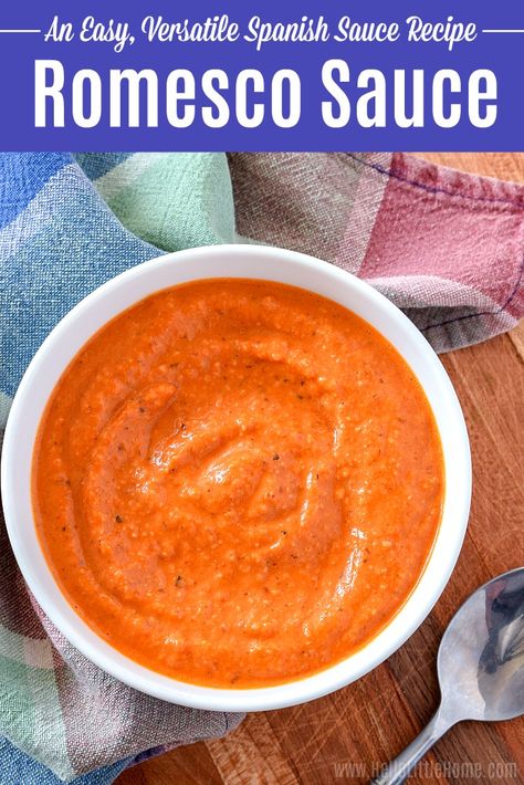 Learn how to make Romesco Sauce at home! Salsa Romesco is an easy Spanish Sauce that’s a great addition to any dinner! This healthy Romesco Sauce recipe uses simple ingredients: tomatoes, roasted red peppers, almonds, garlic, smoked paprika, vinegar, and olive oil. Authentic Romesco Sauce has many uses: top pasta, roasted vegetables, fish, chicken, or meat, or serve as an appetizer with calçots or crudité. Perfect for Spanish Food lovers, and Gluten free, vegan, vegetarian! | Hello Little Home Paprika Sauce Recipe, Romesco Recipes, Spanish Sauces, Spanish Sauce Recipe, Veggie Recipes Breakfast, Spanish Sauce, Tomatoes Roasted, Traditional Spanish Recipes, Romesco Sauce Recipe