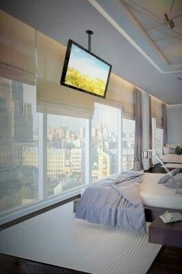 Minimal styled bedroom with city view Tv Mounted, Tv Ideas, Penthouse Living, Suport Tv, Hidden Tv, Bedroom Tv, Bedroom Closet Design, Tv In Bedroom, Condo Living