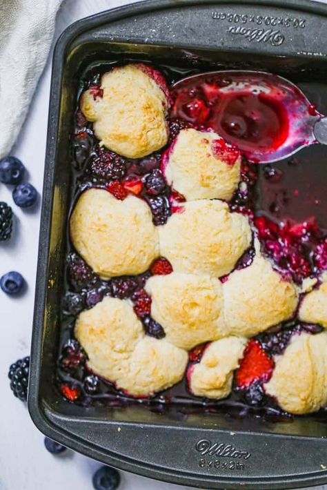 This old-fashioned Very Berry Biscuit Cobbler is one of the most comforting desserts for summertime!  Bring on the sweet and tart, juicy berries baked with the easiest, homemade biscuit dough OK? It’s the ultimate easy traditional dessert that brings everyone to the table!   This cobbler is absolutely dreamy warm right out of the oven, but can also be served at room temperature. We love it for breakfast too!  I am guilty of having it for my meal.  #notsorry as they say.  What I love about this r Homemade Biscuit Dough, Biscuit Cobbler, Firecracker Cookies, Mixed Berry Cobbler, Fruit Biscuits, Berry Cobbler Recipes, Homemade Biscuit, Frozen Biscuits, Berry Cobbler