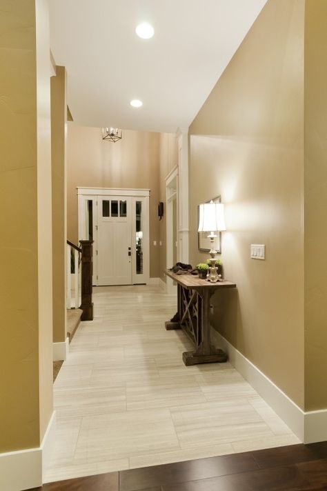 Light tile with a seamless transition to dark wood floor. Perfect! Love the color on the walls! Grey Floor Tiles Living Room, Hallway Dark, Dark Wood Floor, Light Hallway, Wood Grain Tile, Entryway Tile, Tile Floor Living Room, Living Room Wood Floor, Grey Floor Tiles