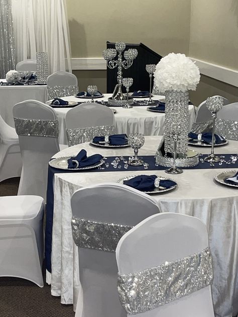 Blue Silver And White Table Decor, Diamond Gala Theme, Midnight Blue And Silver Wedding Theme, Navy And Silver Wedding Decorations, Senior Serve Table Ideas High Schools, Silver And Blue Wedding Theme, Silver And White Centerpieces, Blue And Silver Quince, Navy Blue And Silver Wedding Decorations