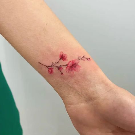 Simple Watercolor Cherry Blossom Flower Wrist Tattoo Idea & Design on Woman Wrist Simple Cherry Blossom Wrist Tattoo Done At Cherry Wrist Tattoo, Cherry Blossom Tattoo Simple, Simple Cherry Blossom Tattoo, Cherry Blossom Wrist Tattoo, Flower Wrist Tattoo, Clavicle Tattoo, Bluebird Tattoo, Wreath Tattoo, Wrap Tattoo