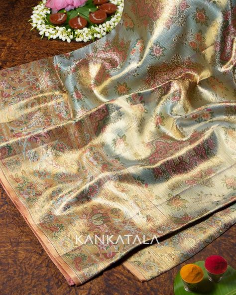 Acquire this opulent sky-blue Kanchipuram silk tissue butta saree for your big day and feel like a queen in the true sense. The Kanchipuram Kalyan Pattu carries a delicate gold zari tissue base and is topped with silver zari bewitching floral buttas. #festivecollection #kankatalakanchipuram #kanchipuramsarees #kanchipuramsilk #tissuesilk #silk #saree #silksaree #weavesofindia #indianhandloom Kanjeevaram Tissue Silk Saree, Tissue Kanjivaram Sarees, Pista Saree, Silk Tissue Saree, South Indian Bride Saree, Blouse Designs High Neck, Kanjivaram Sarees Silk, Bridal Sarees South Indian, Indian Bridal Sarees