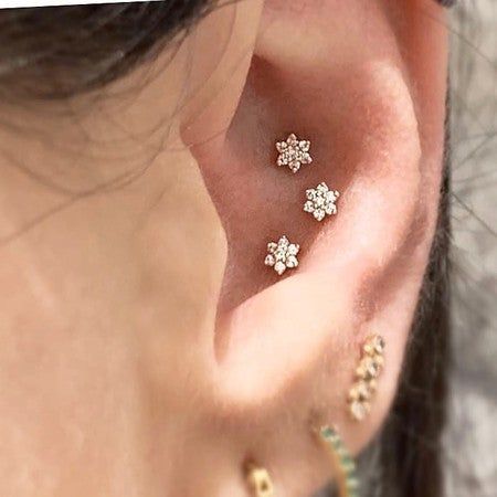 Our flower studs — each with six diamond petals and a round diamond center — bloom brilliantly in the Conch. Triple Conch, Triple Conch Piercing, Conch Piercing Stud, Conch Stud, Conch Piercings, Diamond Baguette, Maria Tash, Conch Piercing, Diamond Flower