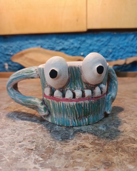 The monster mug can't wait for the kiln. #ceramic #ceramics #coffeecup #coffemug #mug #coffee #cup #etsyseller #etsy #etsyshop Clay Monster Ideas, Monster Mugs Ceramics, Ceramic Mugs Designs Creative, Monster Ceramics, Clay Mug Ideas, Monster Mugs, Monster Cup, Monster Mug, Workshop Inspiration