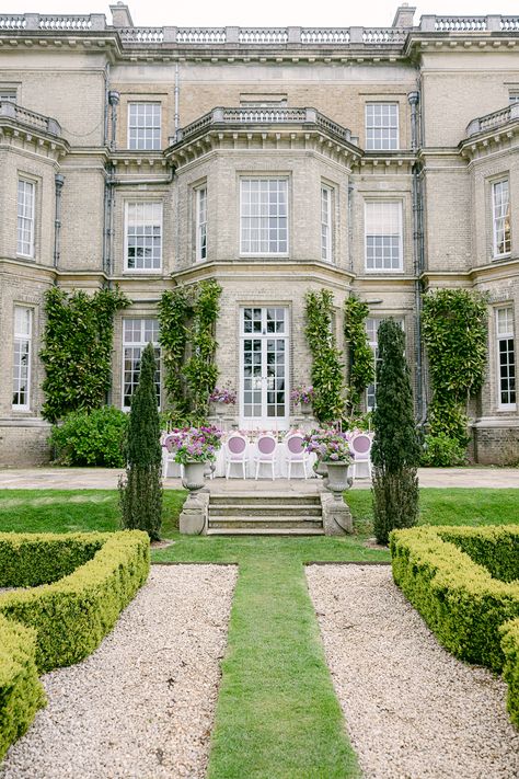 Gaze upon a scene that blends the majesty of nature with the timeless grandeur of Hedsor House. From a distance, this captivating tableau unfolds, revealing a dreamscape where gardens embrace the whispers of history and love. In the foreground, lush and vibrant, the gardens unfurl like an emerald carpet, inviting you to explore their hidden wonders. The delicate petals of blooming flowers dance in harmony with the gentle breeze as if sharing secrets with the centuries-old trees. Wedding Editorial Photography, Uk Houses, Sharing Secrets, Dream Wedding Locations, Hedsor House, English Manor Houses, Destination Wedding Photos, English Manor, Table Scape