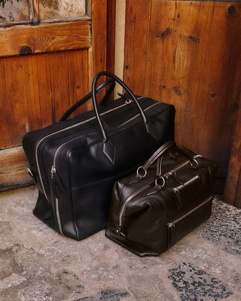 Two luxury black leather holdall bags set on floor against wooden doors. This image was included in the article: 16 Luxury Bag Brands That Are Worthy Of Your Everyday Essentials, on MensFlair.com Leather Gifts For Him, Luxury Bag Brands, Louis Vuitton Keepall 45, Keepall 45, Leather Holdall, Holdall Bag, Leather Weekender Bag, Leather Weekender, Louis Vuitton Keepall