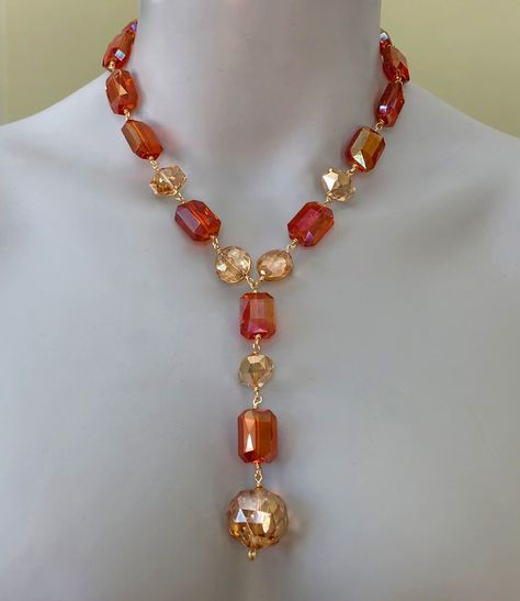 "This crystal statement necklace is full of sunny colour and sparkle.  It will be a spectacular addition to your summer/resort wardrobe but can be worn year-round as well. To create it, I used mystic sunset orange crystal rectangles and mystic citrine crystal coins, geometrics, rondelles and ball.   Using gold non-tarnish wire, I wire-wrapped the crystals to one another in a Y shape so that the drop traces the décolletage.   Length:  18.5\" + 4\" drop." Diy Necklace Making, Keshi Pearl Necklace, Turquoise Statement Necklace, Necklace Orange, Gray Necklace, Crystal Statement Necklace, Sunset Orange, Orange Crystals, Citrine Necklace