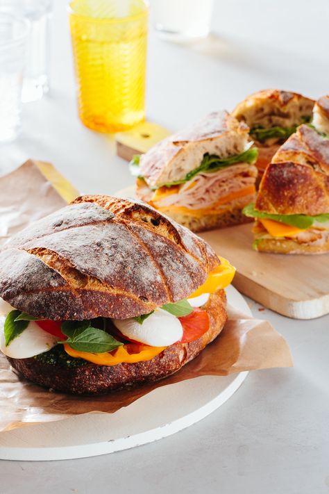 If you're looking for food for a large crowd, look no further than this guide for making a sturdy, stable, DELICIOUS, caprese sandwich. Perfect for parties or picnics, and it's a cheap and filling way to feed guests dinner. Be sure to follow our deli-approved guide to building the perfect sandwich. Summer Dinners For A Crowd, Sandwich For A Crowd, Dinners For A Crowd, Caprese Sandwich, Easy To Make Dinners, Lunch Appetizers, Dinners To Make, Beach Meals, Party Foods