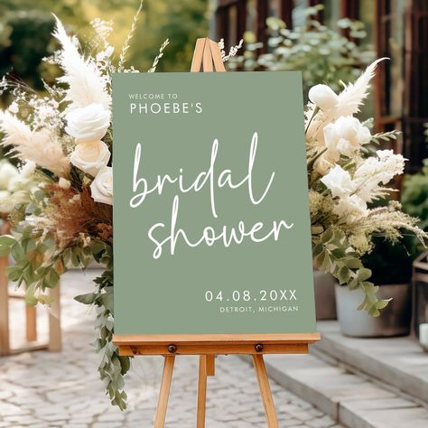 [PaidLink] Make A Stylish And Chic First Impression With This Sage Minimalist Script Bridal Shower Welcome Sign. This Modern Bridal Shower Decor Features A Simple Yet Elegant Minimalist Script Font That Effortlessly Sets The Tone For A Sophisticated Soiree. With Its Minimalist Script Font And Calming Sage Green Color, This Sign Is Perfect For The Modern Bride Who Wants Her Bridal Shower Decor To Feel Chic And Refined. Hang This Beautiful Welcome Sign To #simpleneutralbridalshowerdecor Bridal Shower Decorations Elegant Brunch, Bridal Shower Ideas Plant Themed, Succulent Themed Bridal Shower Ideas, Green Wedding Shower Ideas, Wedding Shower Decor Ideas, Bridal Shower Ideas Sage Green, Diy Bridal Shower Sign, Green And White Bridal Shower Decor, Emerald Green Bridal Shower Ideas