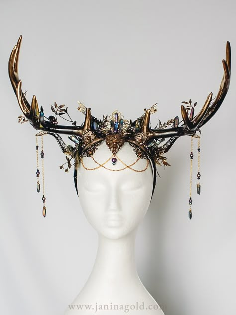 Make a statement with this stunning black and gold fantasy headpiece featuring intricate filigrees, antlers, and sparkling titanium quartz crystals. With elegant touches of purple pearls, this headpiece is the perfect accessory for any special occasion. Whether you're looking for a unique wedding headpiece, a bold costume accessory, or a standout piece for a photoshoot, this headpiece is sure to turn heads. Shop now and add a touch of glamour to your look! Deer Antlers Headpiece, Fantasy Antlers Headdress, Fantasy Head Piece, Antler Crown Headpieces, Bone Headpiece, Fae Headpiece, Fantasy Jewelry Headpieces, Druid Headpiece, Head Jewelry Headpieces