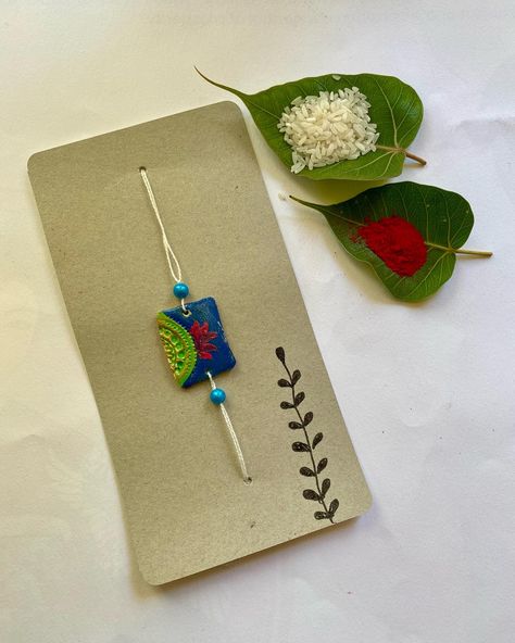 Handmade clay rakhi Mouldit Clay Rakhi, Clay Rakhi Ideas, Handmade Rakhi Designs Diy, Clay Rakhi Design, Rakhi Cards Handmade, Polymer Clay Rakhi, Rakhi Ideas Handmade, Embroidery Rakhi, Rakhi Photography