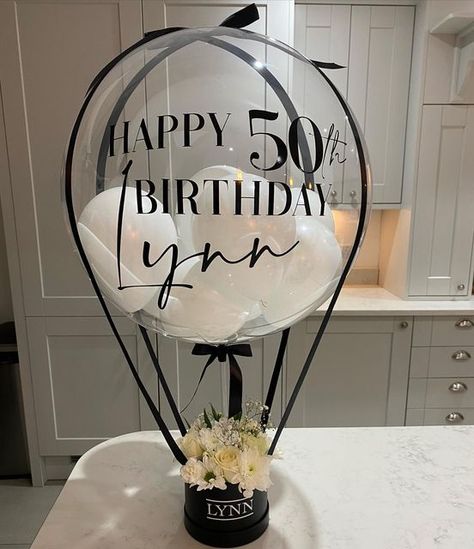 🌸 ROSIE’S BALLOON BAR 🌸 on Instagram: "HAPPY 50th BIRTHDAY!! hot air balloon with small hatbox, and fresh flowers 🥳😍 ✨message me for prices✨ #balloons #gift #birthday #hotairballoon #bubbleballoon #personlisedballoons" Birthday Bobo Balloon Ideas, Mom 50th Birthday Ideas Gifts, Bobo Balloon Ideas Birthday, Happy Birthday Balloons Bouquet, Small Balloon Bouquet Ideas, Gift With Balloons, Birthday Balloons Bouquet, Moms 50th Birthday Gift, Balloon Boutique