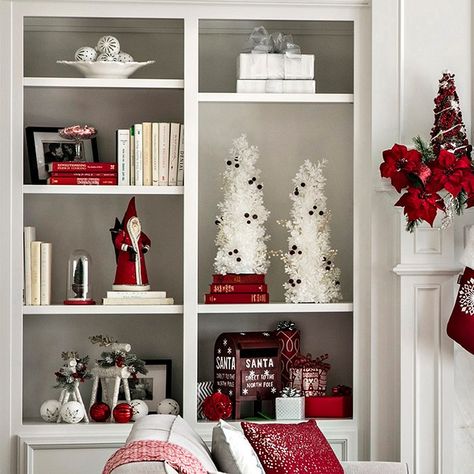 Decorate shelves and built-ins with Christmas charm.  Accent everyday items with the addition of Santa and deer figurines, white trees with berries, ornaments, wrapped gift boxes and Santa's mailbox. Christmas Bookshelf Decor Living Room, Christmas Bookshelf Decorating Ideas, Christmas Shelf Decor Ideas Living Room, Christmas Built In Shelves Decor, Decorating Bookshelves For Christmas, Christmas Bookshelf Decor, Christmas Bookcase, Decorating Built In Shelves, Newyear Decoration