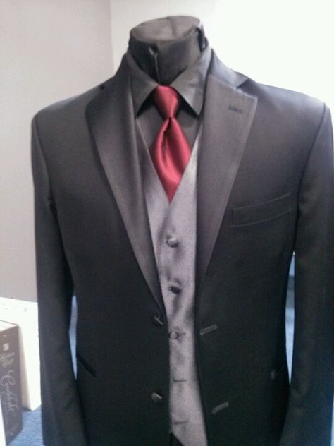 Black tux, black shirt, red tie, charcoal vest. Love this, with the black shirt. Nice silver tie though? With a dark purple vest? Black Tux Black Shirt, All Black Tuxedo, Mens Tux, Grey Tux, Wedding Clothing, Black Tux, Red Vest, Tuxedo Wedding, Red Tie