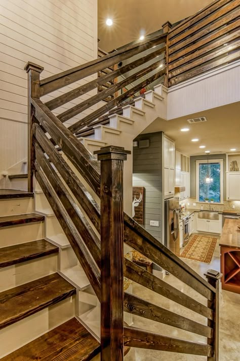 This blue farmhouse features a contemporary country design and includes reclaimed wood throughout the home. Board-and-batten paneling is used prominently, as are rustic design elements such as the wood stair rails and vaulted wood ceiling. Rustic Farmhouse Interior, Farmhouse Stairs, Rustic Stairs, Stair Railings, Railing Ideas, Farmhouse Interior Design, Staircase Ideas, Staircase Railings, Lan Can