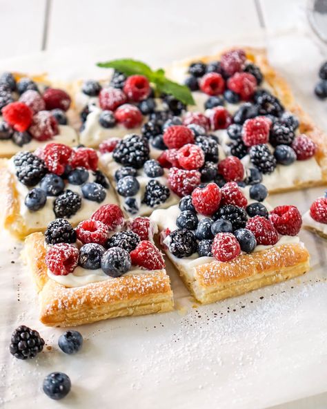 This simple berry cheese tart is a fun cross between a lazy man's tart and a cheesecake but it's made with puff pastry and fresh fruit.