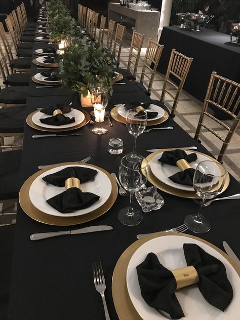 Table for 30 people. Great conversation between at least 12 people because of how wide tables were. Names printed on gold paper and rolled around napkin to created bow tie. Black Tie Masquerade Party Ideas, Table For 30 People, Black Tie Event Decor, Black Tie Decorations Party Ideas, Black White And Gold Table Setting, Maroon Green Wedding, Gold And Black Table Setting, New Year Table Decor, Black Table Setting