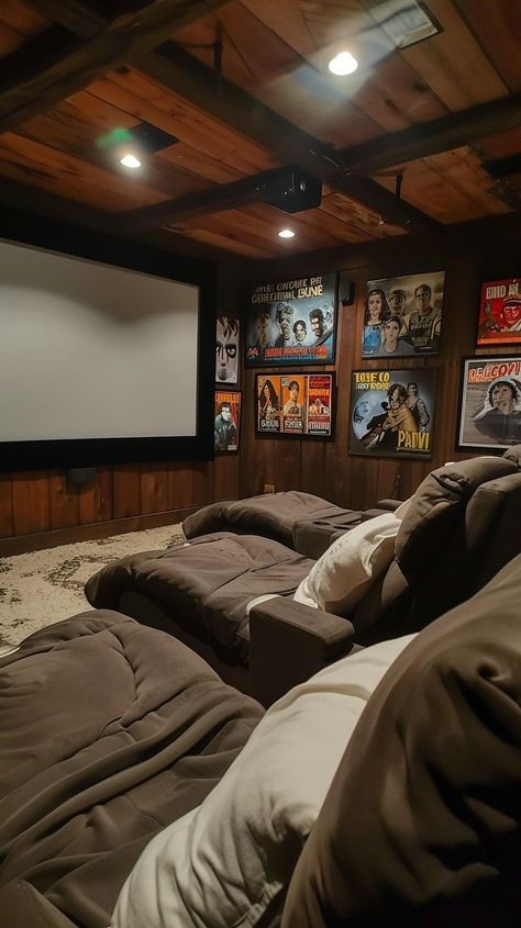 Rustic home theater with plush seating, wooden paneling, and classic movie posters for immersive viewing experience Wooden Paneling, Home Cinema Room, Classic Movie Posters, Theatre Poster, Cinema Room, Inviting Home, Home Cinemas, Rustic Home, Home Theater