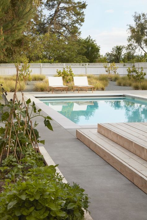 Stepstone handmade, pre-casted concrete for the pool coping and an acid-etch finish (sometimes called water-wash finish) on the poured concrete. The light coloration of the coping creates a tone-on-tone contrast to the concrete.  The designers worked with Bertram Pools to construct the pool and specified white plaster for a refreshing feel. Recycled Garden Projects, Pool Decking Concrete, Poured Concrete Patio, Concrete Pool, Modern Pools, Landscape Architecture Design, Backyard Pool Designs, Up House, Garden Pool