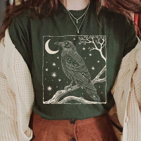 Vintage Raven Shirt, Celestial Shirt, Cottagecore Shirt, Forestcore T-Shirt, Witchy Shirt, Crow, Vintage Linocut Illustration. 📣 INFORMATION * All shirts are UNISEX * 100% Airlume combed and ringspun cotton (fiber content may vary for different colors) * Wash and dry normally (on cool for best results) 👕 SIZING * For an oversized fit, select two or three sizes up from your normal size * Model is wearing size L * Sizing runs true to size * Most women find their typical size works best, since th Celestial Style Fashion, Womans Graphic Tee, Witchy T Shirt Ideas, Dark Cottagecore Summer Outfits, Witchy Cottage Core Outfits, Cute Vintage Clothes, Cute Collared Shirts, Everyday Clothes, Shirts Aesthetic