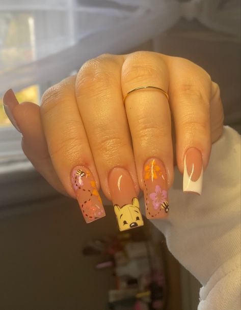 A nude gel-x tapered square nail set with Winnie the Pooh and light spring themed art Cute Winnie The Pooh Nails, Nail Ideas Characters, Whitney The Pooh Nails, Whinney Pooh Nails, Winnie The Pooh Valentines Day Nails, Summer Nails Disney, Artist Nails Design, Pooh Bear Nails Acrylic, Disney Nail Ideas For Short Nails