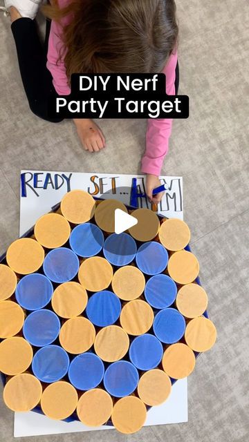 Hayley Cain | Instructional Coach on Instagram: "🧡💙DIY Nerf Party Target We are using this in place of a piñata or party favors! The kids will aim and break the tissue paper to find an assortment of candy and surprise cash in a few!  Supplies needed: -Hot glue Gun -Plastic or styrofoam cups(37) -tissue paper -rubber bands -fillers(candy/small toys/cash/etc) -foam board or cardboard  🧡Stuff the cups with candy or small toys. Cut the tissue paper enough to cover the cup and wrap tightly over. Secure with rubber band. You can pull the tissue down to make it tighter. Start in the middle of your board and use dabs of hot glue on the bottom of cup to secure to the board. Alternate the colors and continue until you have the size you want!  We will simply prop this up on a tree and each kids wi Non Candy Pinata Fillers, Piñata Alternatives, Pinata Filler Ideas Non Candy, Diy Nerf Targets, Nerf Targets Diy, Cup Pinata, Diy Nerf Party, Pinata Alternative, Nerf Party Favors