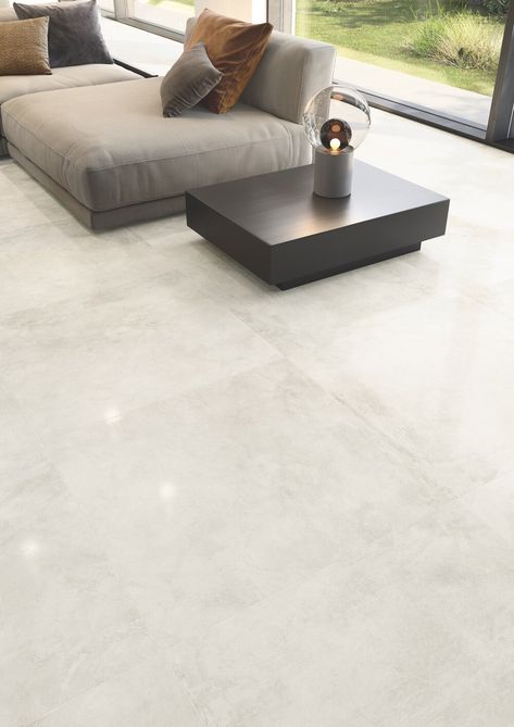 Casalgrande Padana’s Kerinox Bianco lapped tiles embody the reflective nature of metal, brightening this open-plan living area. Floor Tiles Living Room Modern, Floor Tiles Living Room, Modern Floor Tiles, Living Room Floor Tiles, Room Floor Tiles, Laundry Room Tile, Floor Tiles Design, Tiles Living Room, Tile Floor Living Room