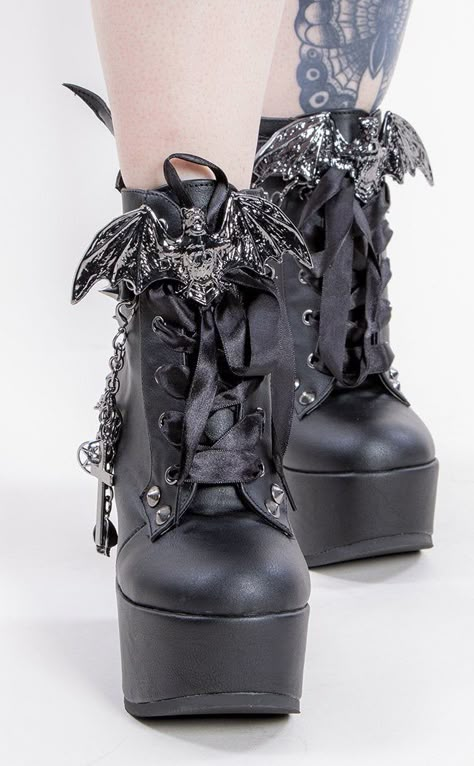 For the tall countesses and vampire lords! The Poison 107s are the most extra platforms for creatures of the night: these comfortable wedges are covered in studs n straps to kill, topped off with bat wings and a bat charm over the laces. Vegan Black PU leather 5 inch platform Bat wing ankle bootie Bat charm Studded straps Side zip Studded heel Removable chain with charms Ribbon lace-up U.S women's sizing-refer to size chart for more info Gothic Accessories Jewellery, Chain With Charms, Goth Outfit Inspo, Formal Ideas, Demonia Boots, Black Vampire, Vampire Clothes, Alternative Shoes, Goth Shoes