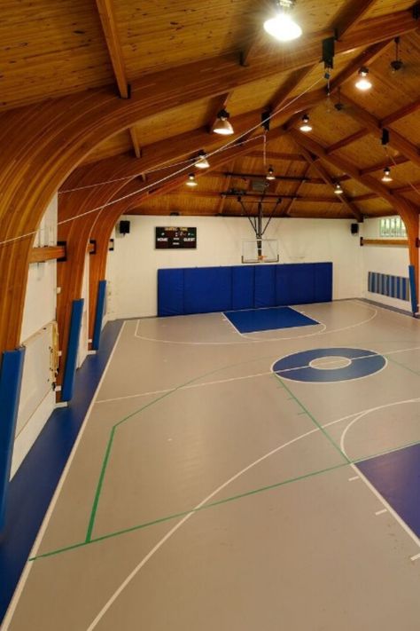 Take a look at this classy indoor basketball court in house! It has a simple design with gorgeous wood ceiling and blue court accents. Definitely a great addition to any home gym. #IndoorBasketballCourt #BasketballCourt  Courtesy of Toptenrealestatedeals.com Basketball Court In House, Indoor Basketball Court In House, Basketball Court Home, Blue Court, Indoor Basketball Court, Baseball Diamond, Adam Jones, Indoor Basketball, Home Lounge