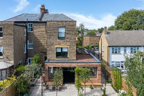 This wraparound extension, by Create Bespoke and Alexander Owen Architecture, is made from an industrially chic combination of reclaimed red stock brickwork with steel-framed glazing. | #renovation #homedecorideas #dreamhome #homeremodel #interiordesign #kitcheninspo #dreamkitchen #kitchendecor #storageideas #stoarge #kitchenstorage #kitchenflooring #industrialhome #kitchenextension #extension #kitchenextensionideas #kbbmag Victorian Terrace Kitchen Extension, Terrace Kitchen Extension, Victorian Terrace Kitchen, Wraparound Extension, Rendered Houses, Types Of Kitchen, Steel Frame Doors, Kitchen Extensions, Glazing Ideas