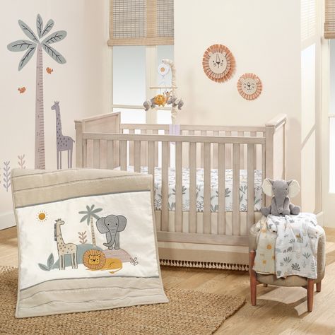 This stylized jungle three-piece crib bedding set will delight your little adventurer. The set includes one quilt, one breathable 100% cotton fitted crib sheet, and one decorative crib skirt. Made in a combination of linen, cotton, twill, jersey, faux suede, and velour fabrications. A majestic giraffe, a gentle heather gray jersey elephant, and a friendly lion made of faux suede are the centerpieces of this safari collection. Gray satin embroidery, a black and white mini checkered pattern inset, and rows of white bean stitches add to the charm. The breathable 100% cotton fitted crib sheet is on a clean white ground with elephants, lions, giraffes, and foliage. There is elastic all the way around ensuring a safe and secure fit on a standard-sized crib mattress measuring approximately 28” X Lion Wall Decor, Mini Crib Bedding, Adventure Wall, Elephant Stuffed Animal, Lambs & Ivy, Baby Crib Bedding Sets, Wall Decor Storage, Welcome Home Baby, Toddler Bed Set