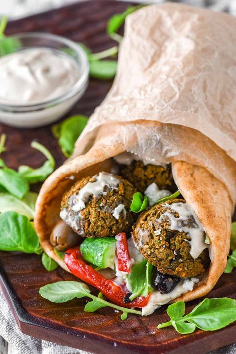 This falafel wrap features baked falafel, customizable toppings, and a drizzle of homemade lemon tahini dressing for a burst of flavor. #falafelwrap #wrap #falafel | chiselandfork.com Falafel Wraps, Falafel Mix, Pain Naan, Sandwich Wraps Recipes, Vegan Appetizer, Falafel Wrap, Homemade Garlic Butter, Baked Falafel, Sandwich Wrap