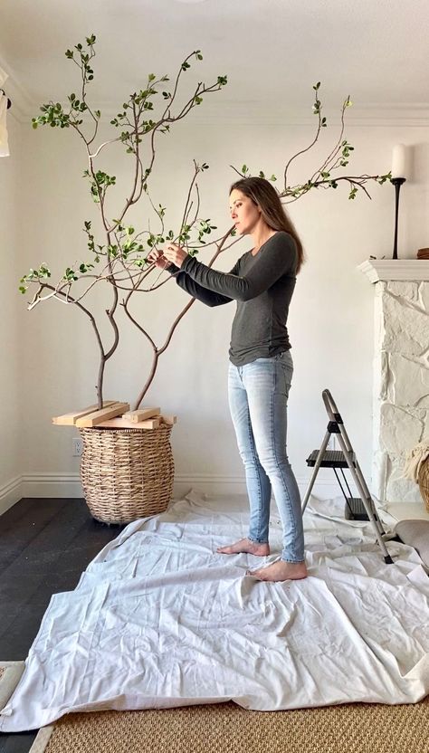 fake tree with woman attaching DIY artificial branches in living room Fake Tree Diy, Make A Fake Tree, Diy Artificial Tree, Faux Tree Branches, Faux Trees, Hanging Plants Diy, Tree Branch Decor, Faux Branches, Indoor Tree