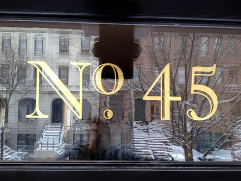 23 karat gold leaf house number House Number Fonts, Transom House Numbers, Fan Light Door Number, Exterior House Number Ideas, Gold Leaf Signage, Door Numbers Ideas, Glass Door Signage, Victorian House Numbers, Painted House Numbers